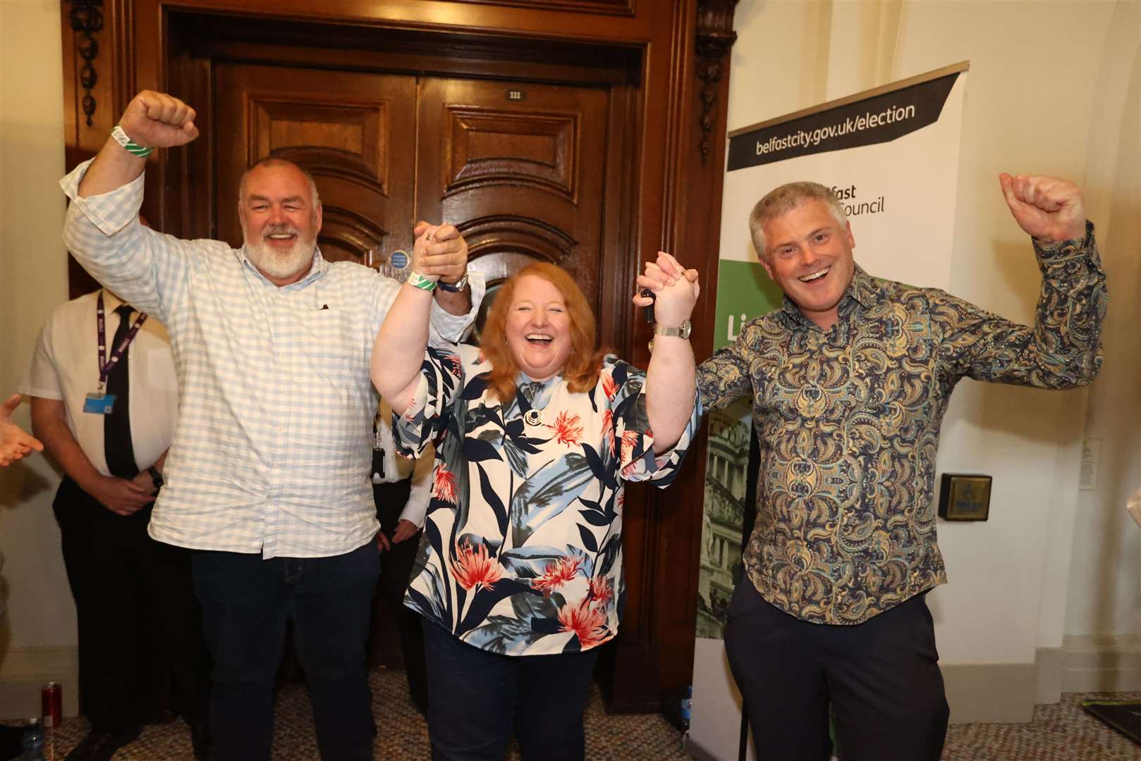 Alliance Party leader Naomi Long (centre) with Eric Hanvey (left) and her husband Michael Long (right) at Belfast City Hall as the results come in for the Northern Ireland local elections (Liam McBurney/PA)