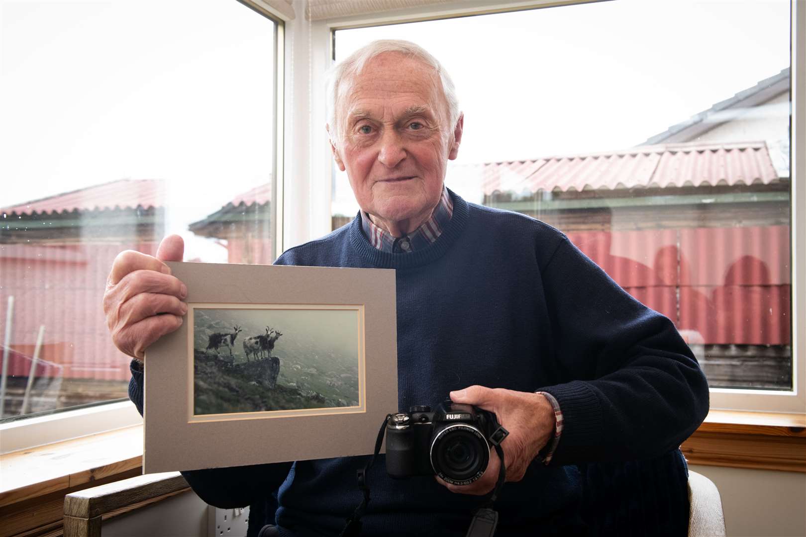 Harry Payne with his wife's favourite photograph: Three wild goats. Picture: Callum Mackay
