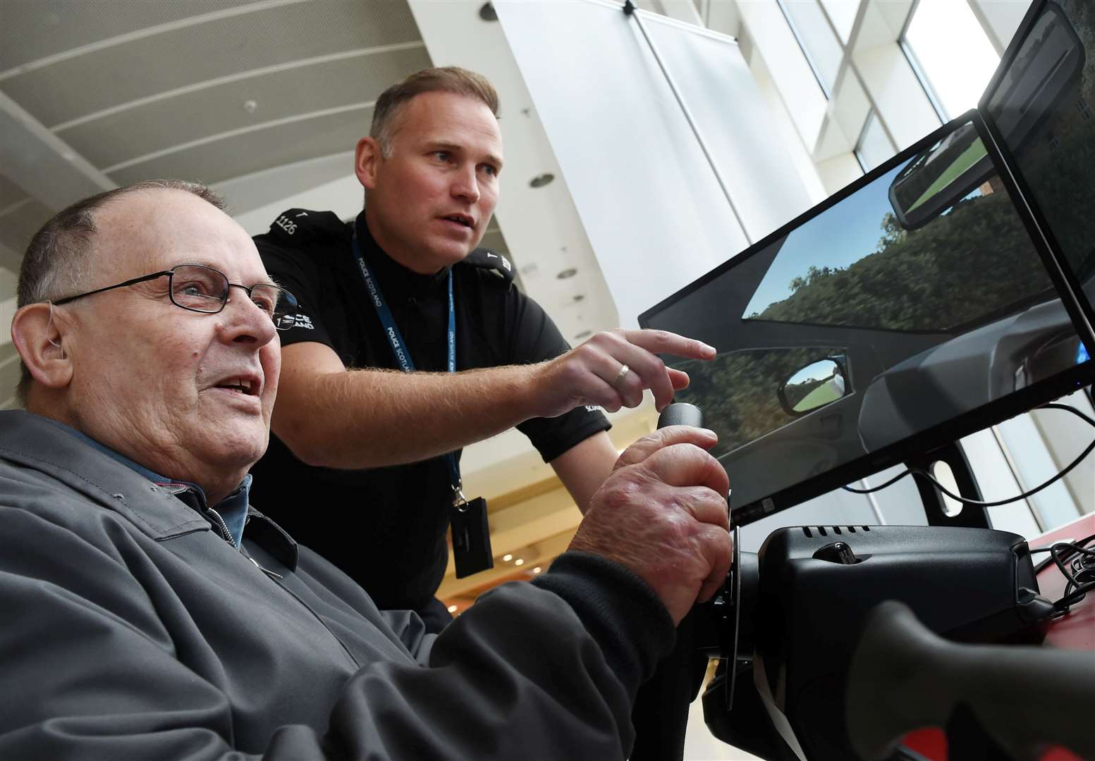 Charles Holmes took the wheel with Constable Neil Macdonald when the driver simulation project visited Inverness last year.