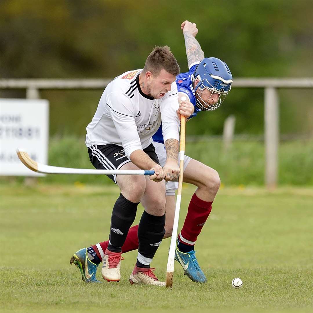 Kyles’ Roddy Macdonald tries to block the swing from Marc MacLachlan (Lovat). Lovat v Kyles Athletic in the MOWI Premiership, played at Balgate, Kiltarlity.