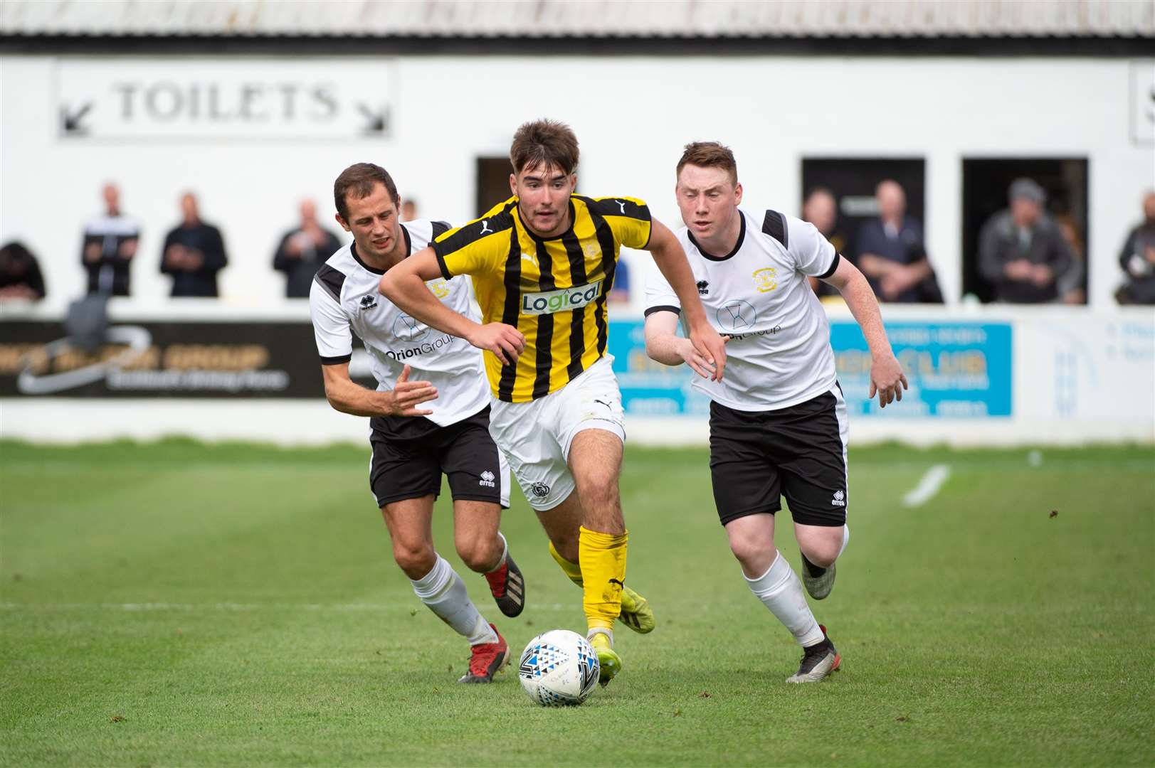 William Hill Scottish Cup Clachnacuddin v Nairn County...Nairn's Max Ewen gets away from Clach defenders Michael Finns and Seamus McConaghy...Picture: Callum Mackay. Image No..