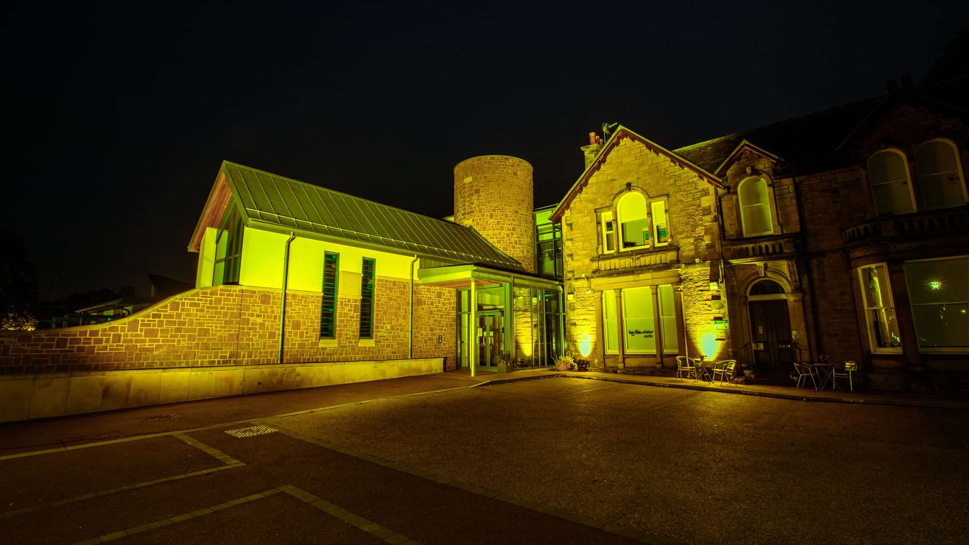 Highland Hospice in bathed yellow light.