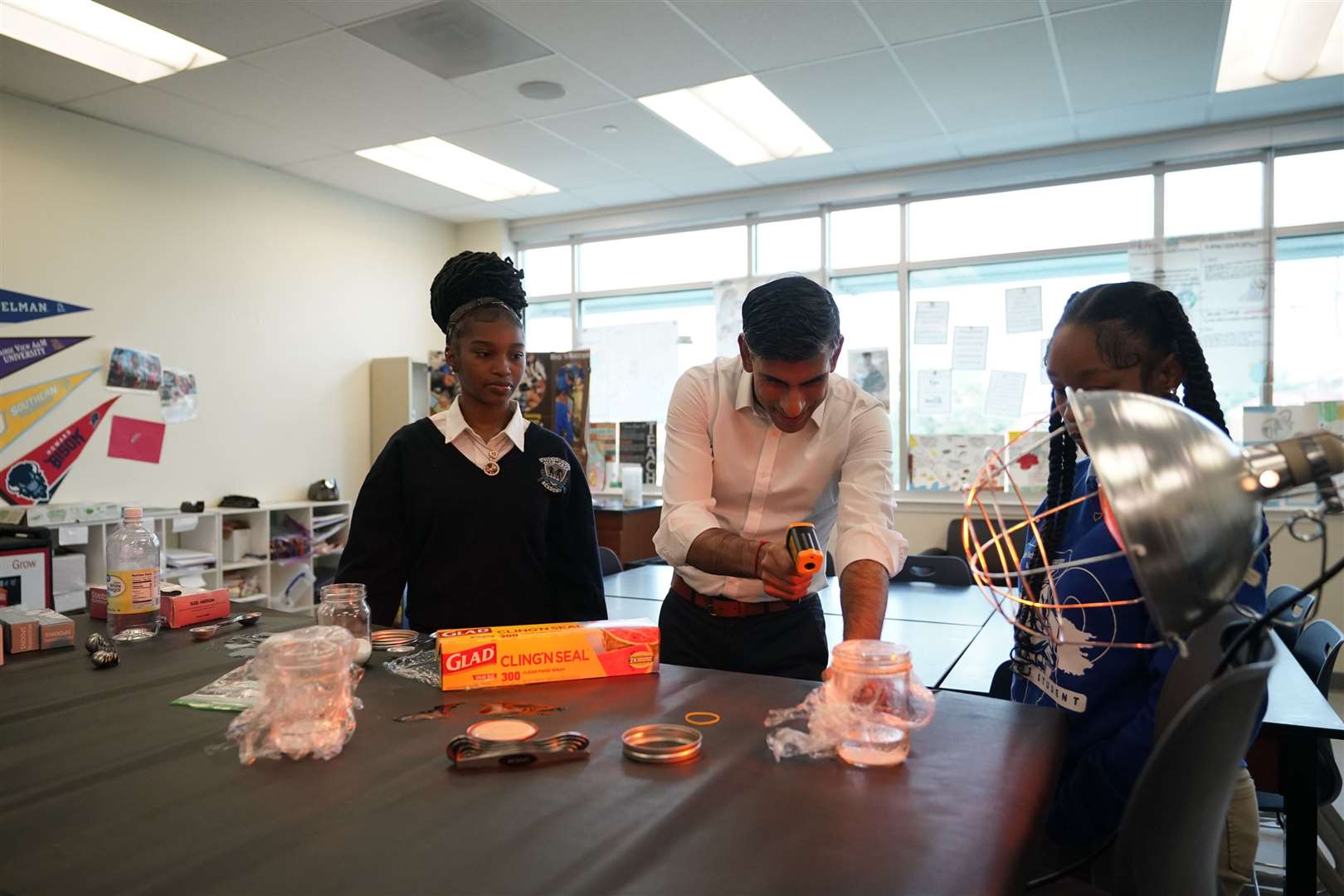 Prime Minister Rishi Sunak takes part in a science experiment as he visits the Friendship Technology Preparatory High School during his visit to Washington DC (Niall Carson/PA)
