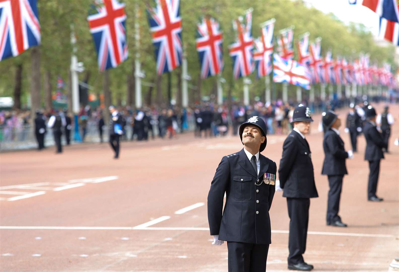 A police officer enjoys the atmosphere on the Mall in London during the Diamond Jubilee celebrations (John Cantlie/PA)