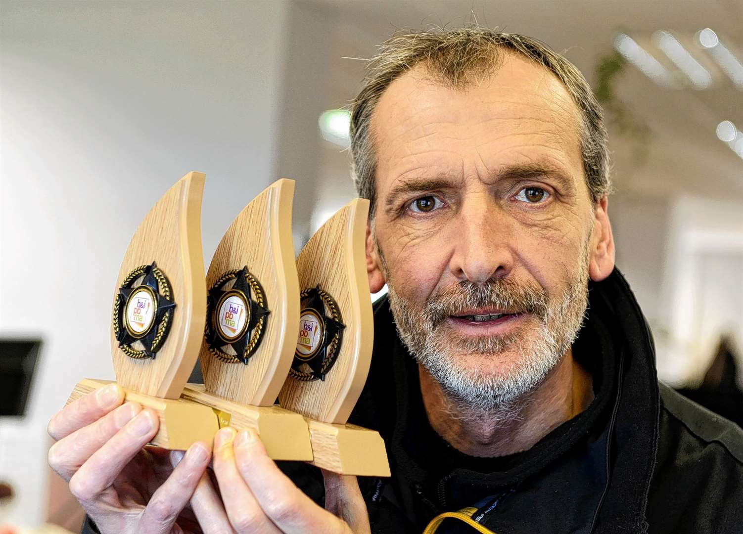 The late Gary Anthony with his hat trick of awards in 2014.