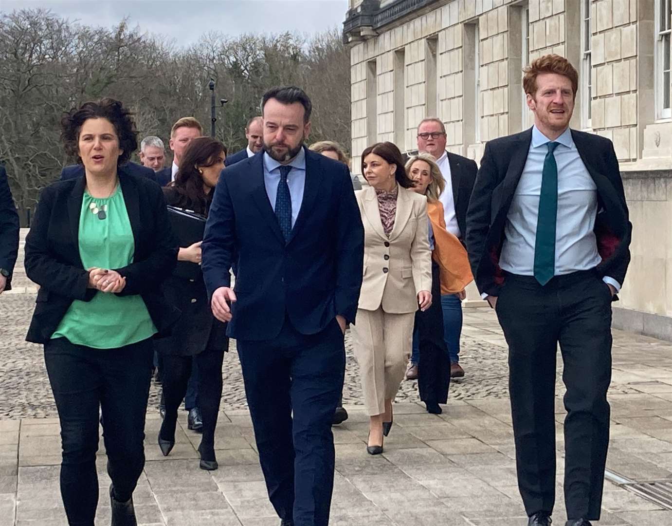 SDLP leader Colum Eastwood (centre), South Belfast MP Claire Hanna (left) and Opposition leader Matthew O’Toole lead their MLAs into Stormont ahead of the first official Opposition day (Rebecca Black/PA)
