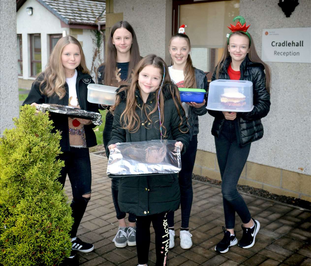Fiona Roehling (13), Iona Rennie (12), Alicia Glendinning (9), Ruby Mackintosh (13) and Paige Glendinning (13) from Culloden bring 50 cakes to Cradlehall Care Home as a treat for the residents.