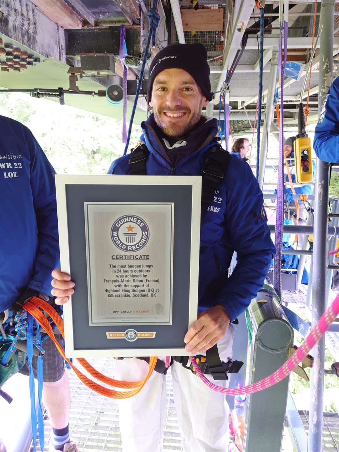 Mr Dibon with his Guinness World Record certificate for having completed the most amount of bungee jumps in 24 hours (Mr Dibon with his Highland Fling crew after smashing the record (Heartland Media and PR/PA))