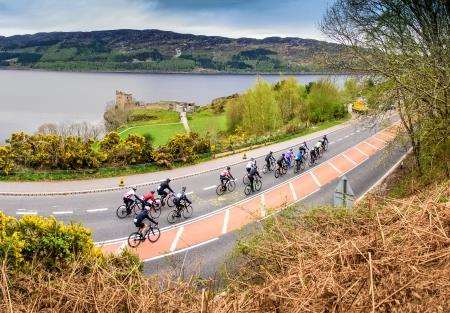 Cyclists ride past Urquhart Castle on the closed A82 during the event on Sunday.