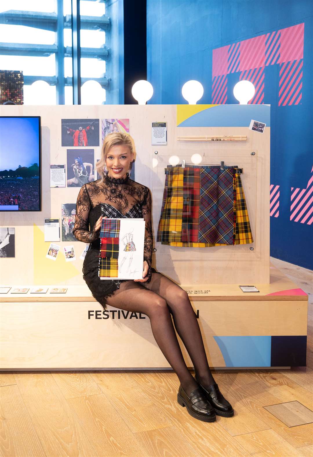 Siobhan Mackenzie beside the bespoke kilt she designed for pop star Self Esteem. It can be seen at the Radio 1 Big Weekend Experience at V&A Dundee until January 7, 2024.