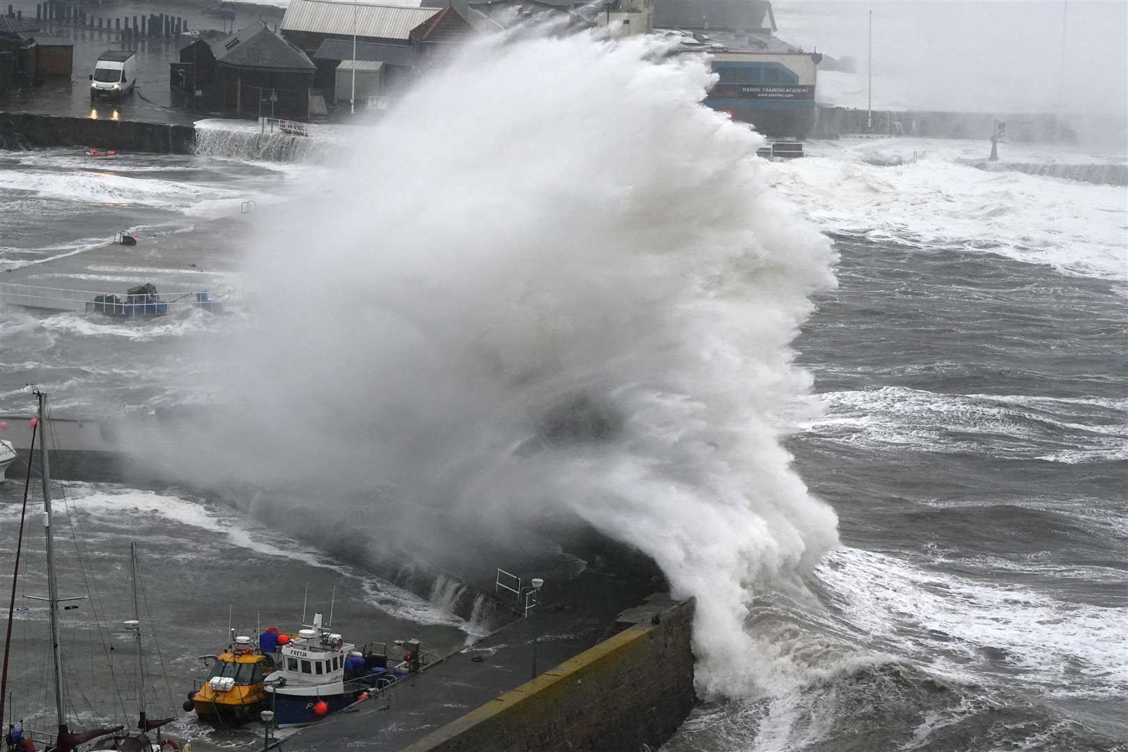 Waves crash on the harbour wall at Stonehaven in Aberdeenshire (Andrew Milligan/PA)