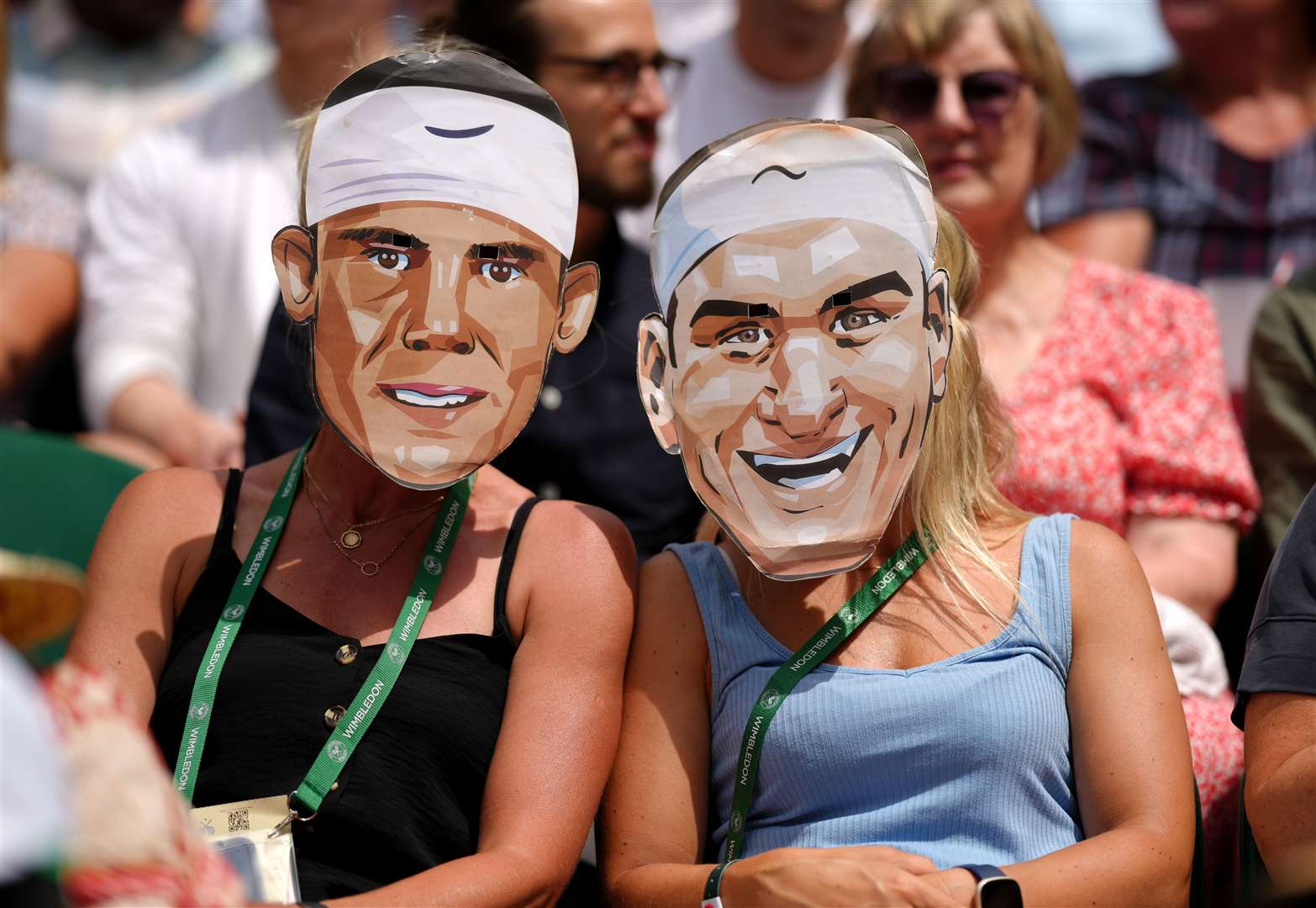 Spectators on centre court sporting face masks of Roger Federer and Rafael Nadal (John Walton/PA)