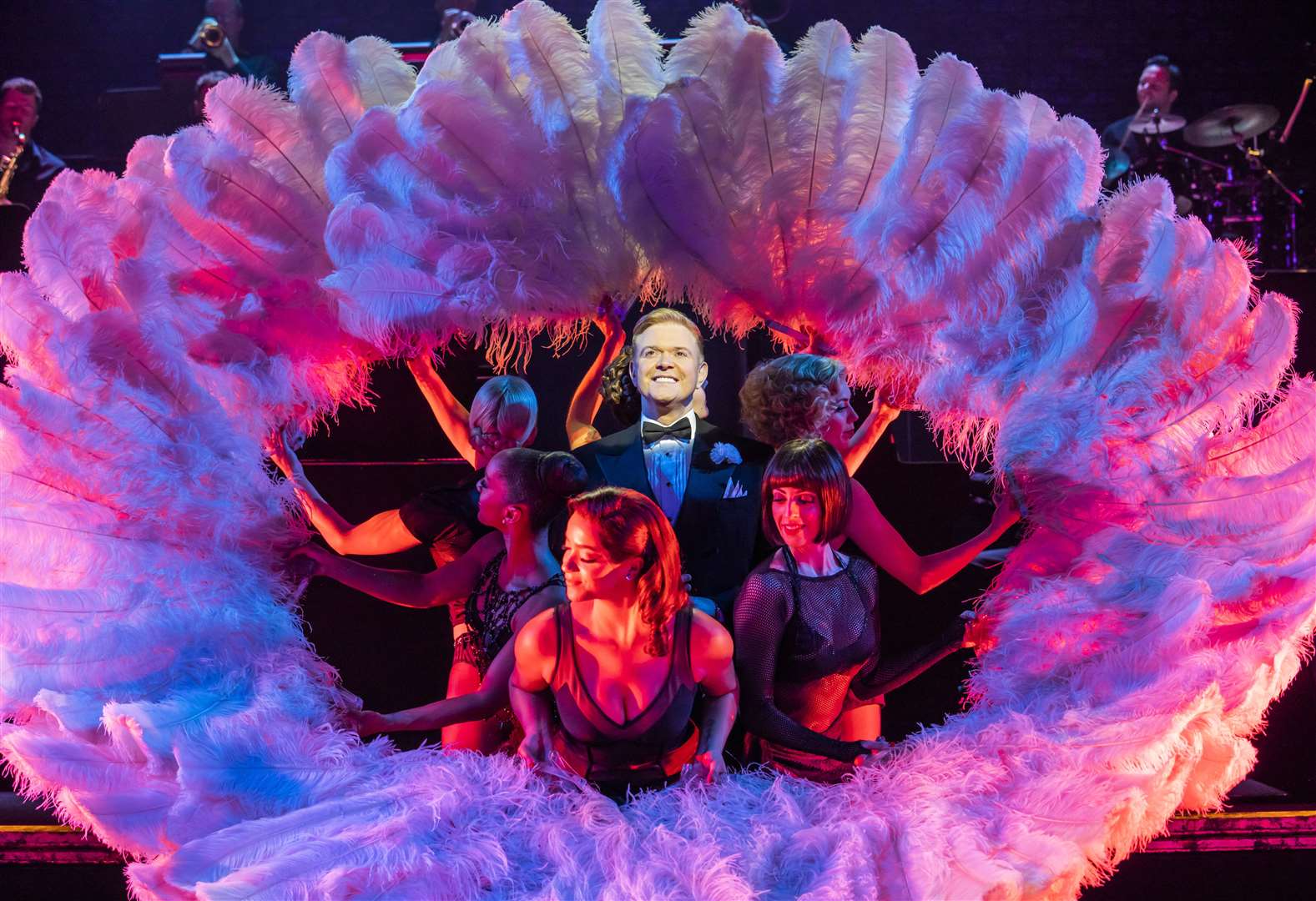 Darren Day as lawyer Billy Flynn surrounded by the company – and ostrich-feather fans! Picture: Tristram Kenton.