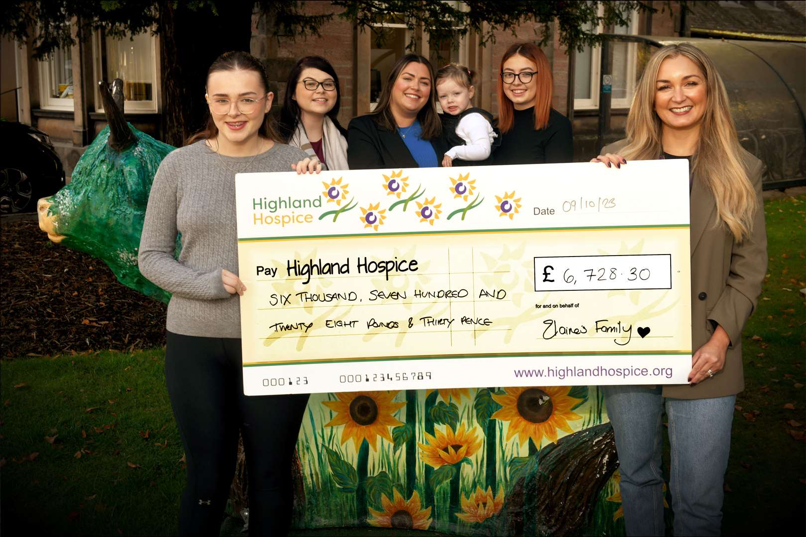 Abbie Thain (left) presenting the cheque to Highland Hospice fundraiser Emma Nicol, along with (from left) Hannah MacKenzie, Lauren Pirie (holding Willow) and Ellie Thain. Picture: James Mackenzie