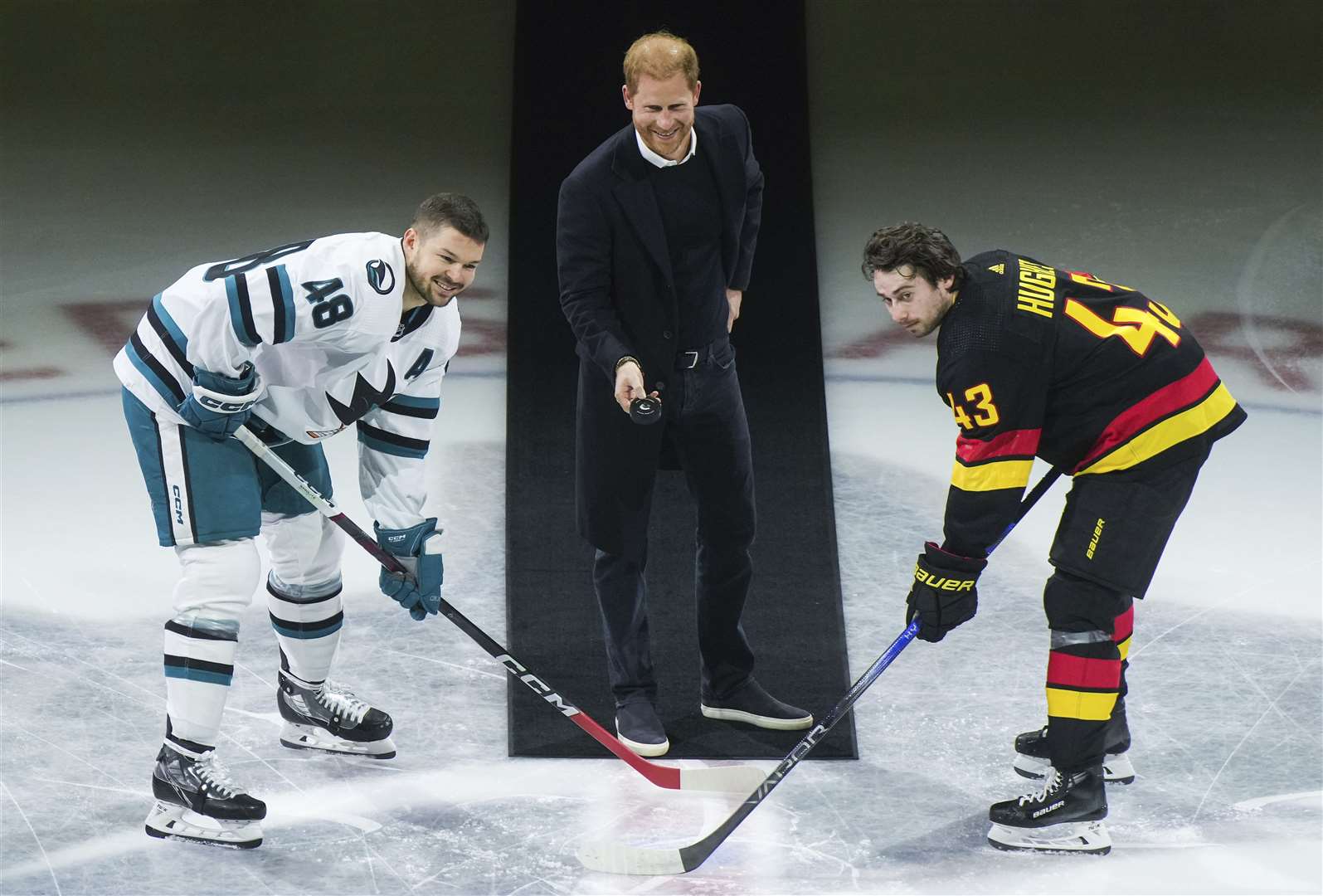Harry drops the puck for during a ceremonial face off prior to an NHL hockey game in Vancouver, British Columbia (Darryl Dyck/AP)