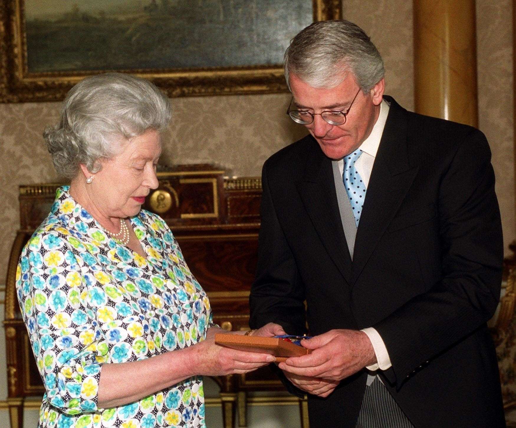 Former prime minister John Major receives the Companion of Honour from the Queen (Rebecca Naden/PA)