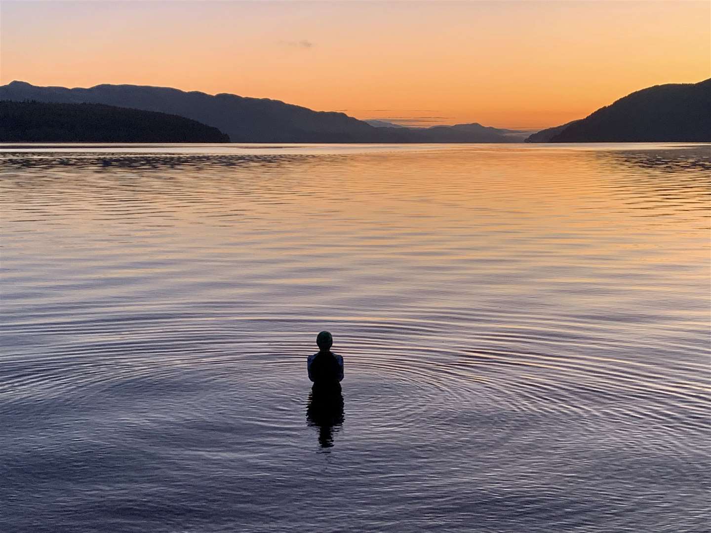 A solitary swimmer takes to Loch Ness at dusk. Picture: Richard Castro
