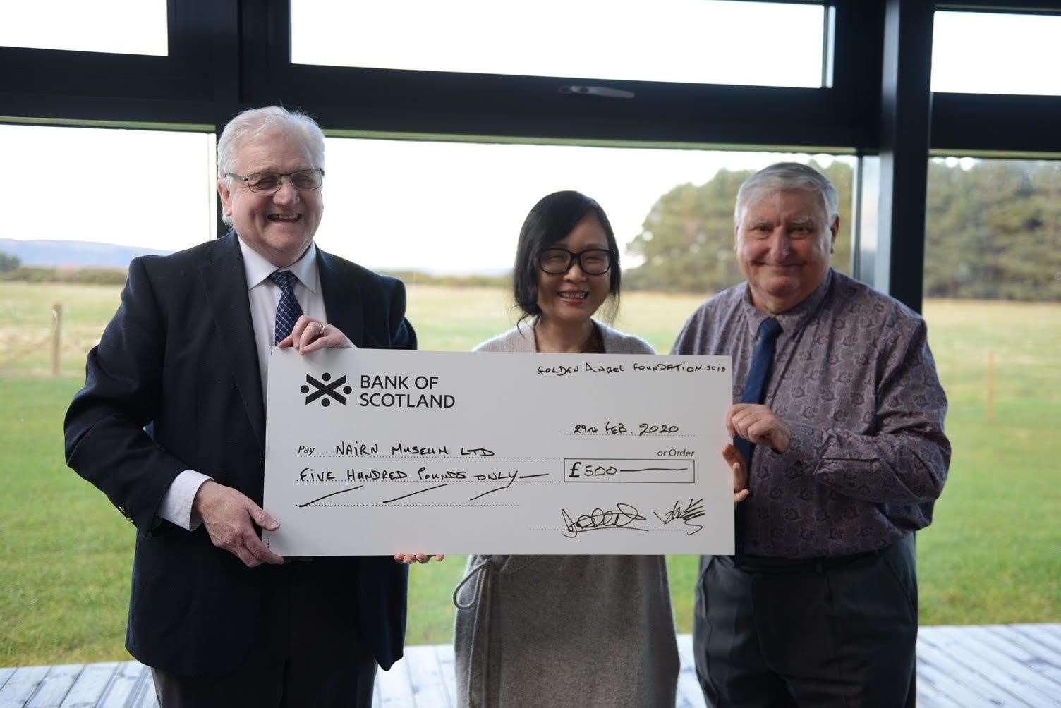 John Urquhart, Nairn Museum trustee receives a cheque for the museum from Diana Xu, Golden Angel trustee and John McCulloch, treasurer of the foundation.