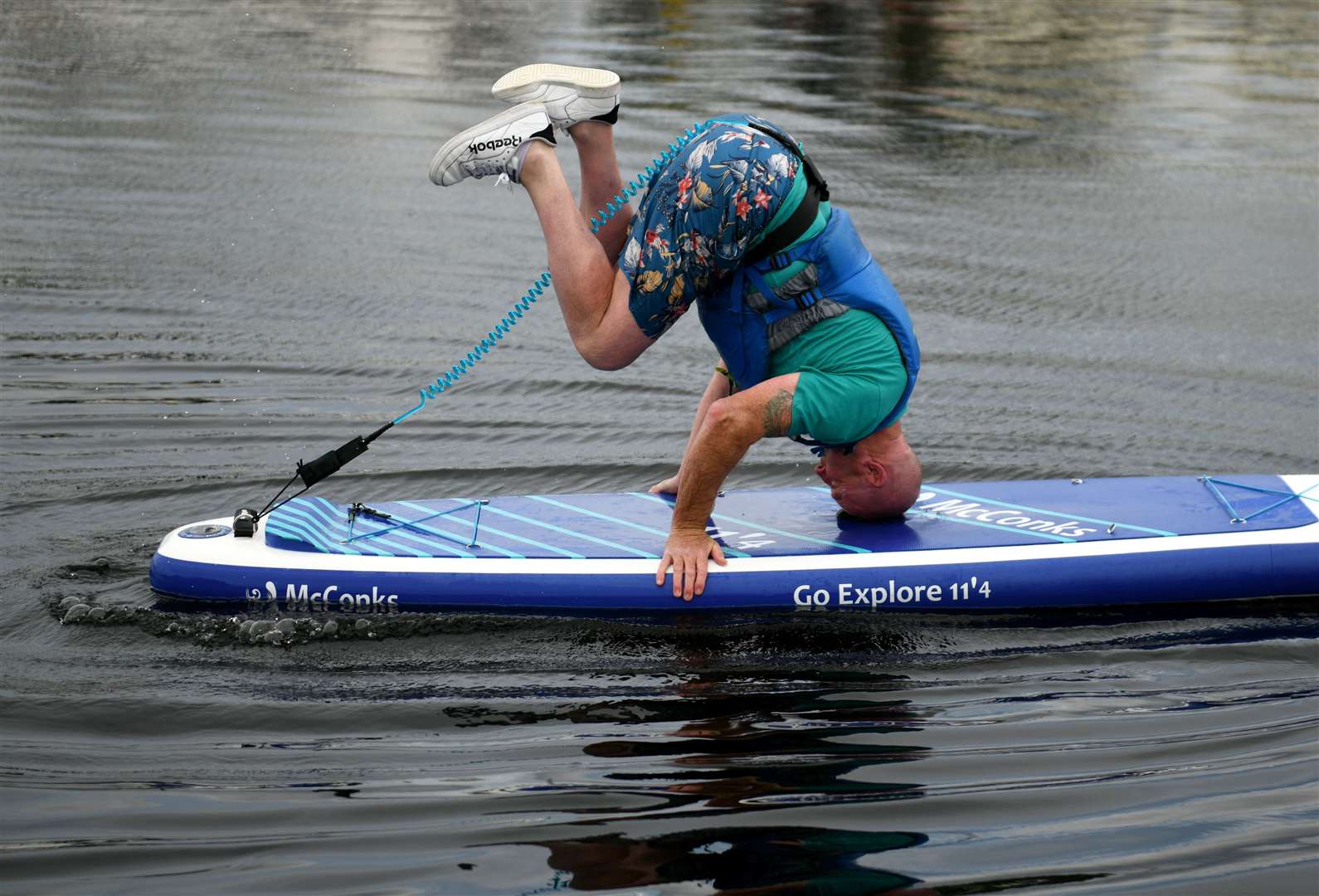 Jim Riddle trying to do a head stand on a paddle board. Picture: James Mackenzie.
