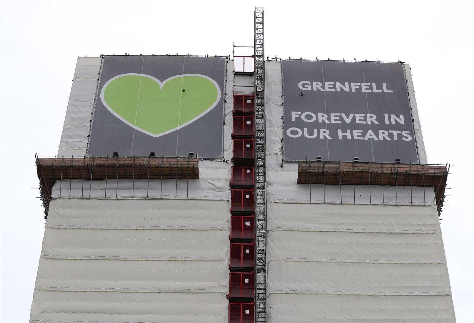 Grenfell Tower as seen from the Grenfell Memorial Wall in the grounds of Kensington Aldridge Academy (Jonathan Brady/PA)