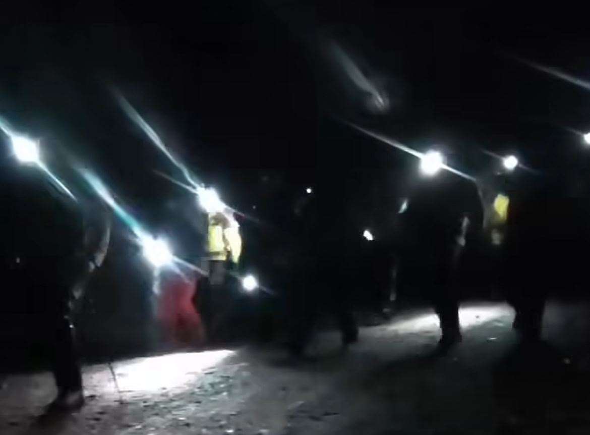 Members of the Cairngorm Mountain Rescue Team light up the way ahead with their head torches.