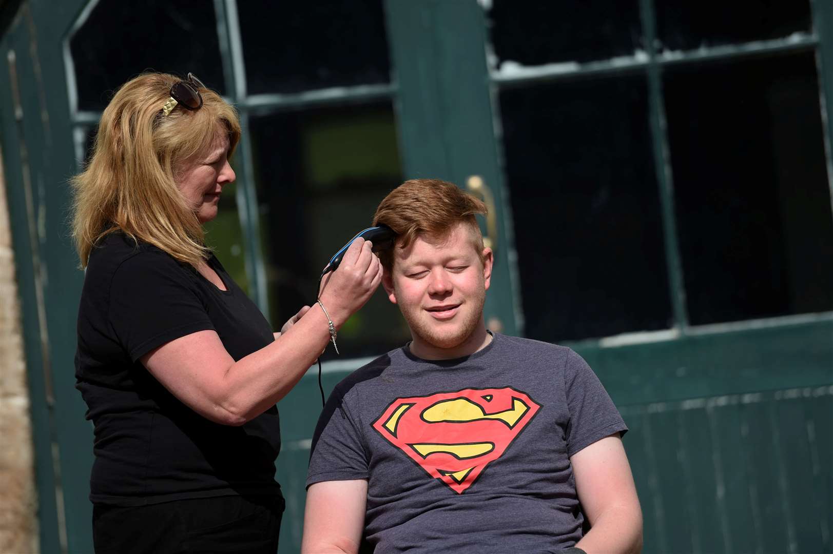 Miriam Veals is the makeshift barber for Harry Ward. Picture: Callum Mackay
