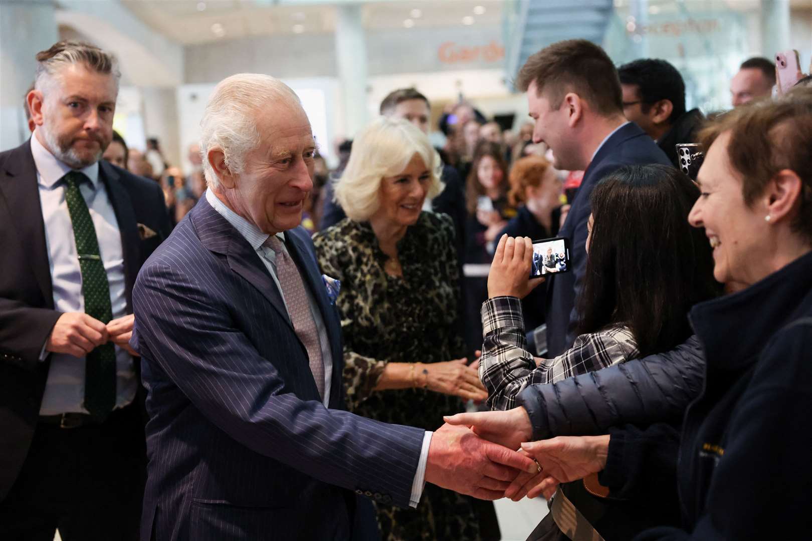 Charles and Camilla meet staff members as they arrive at University College Hospital Macmillan Cancer Centre (Suzanne Plunkett/PA)