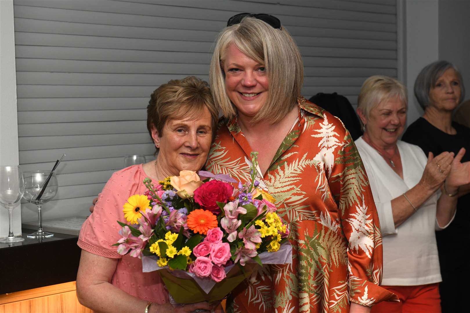 (From left) Anne MacIver of the Black Isle branch of Cancer Research UK is presented with flowers by Georgina Innes. Picture: Alexander Williamson.
