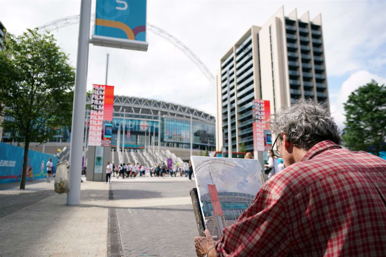 An artist paints a picture of the ground ahead of the Euro 2020 final at Wembley Stadium (Zac Goodwin/PA)