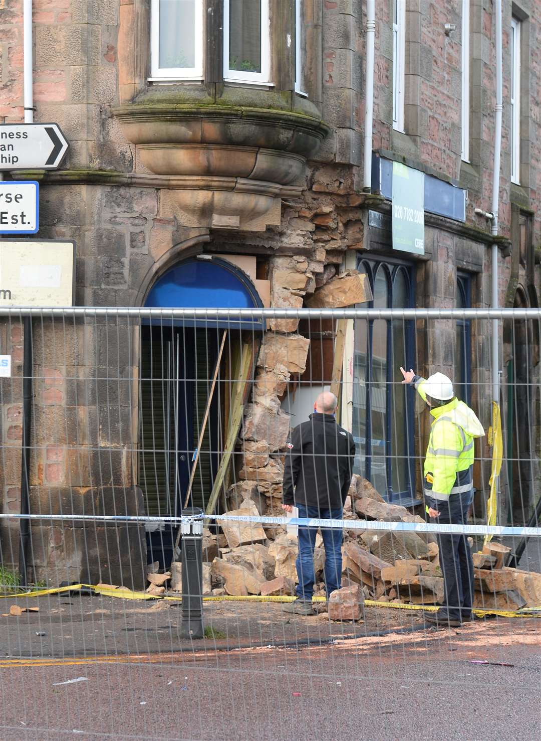 Highland Council surveyors assess damage to the former William Hill building.