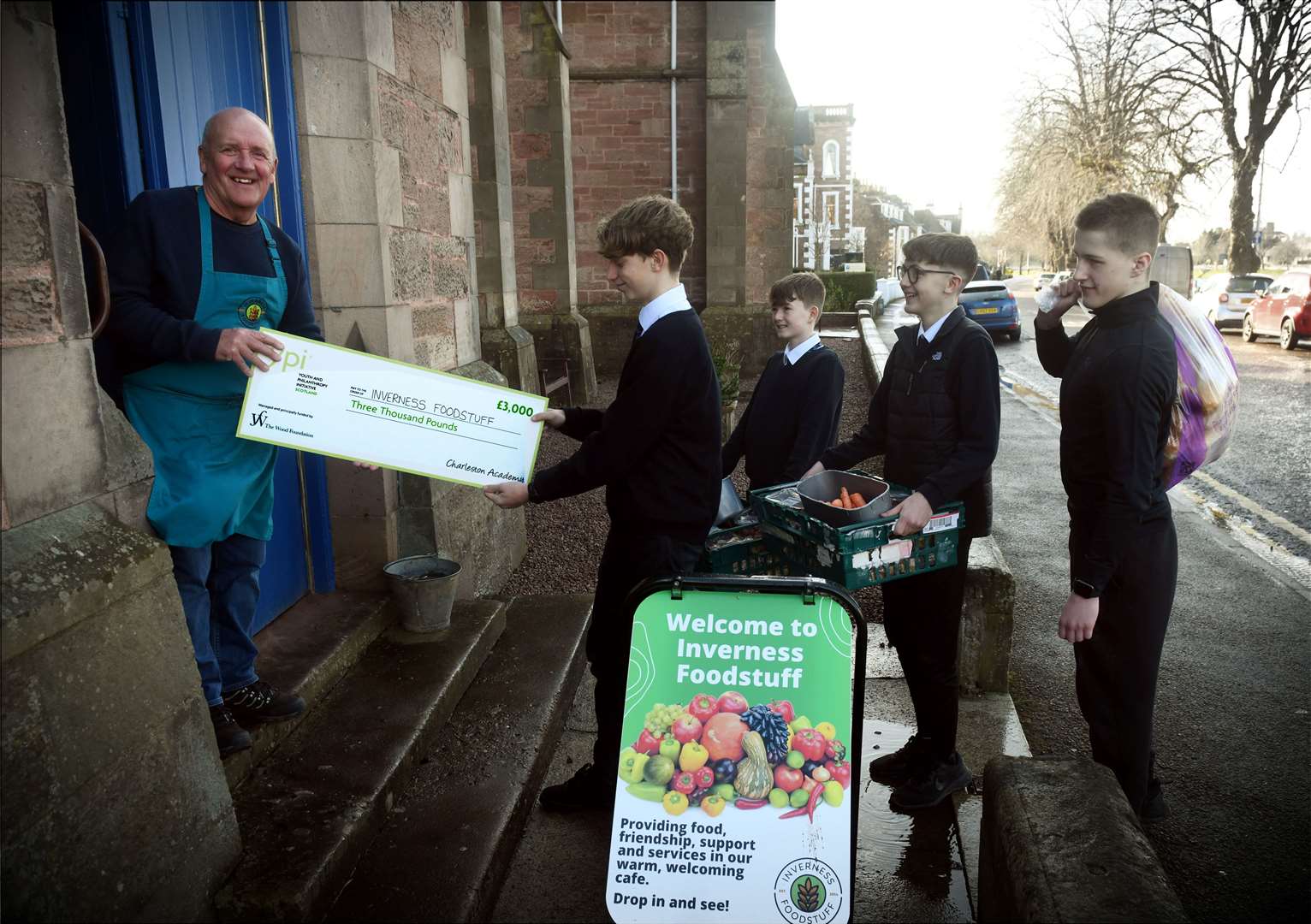 Charleston Academy pupils deliver a £3000 cash boost to Dave Kemp (third right), of Inverness Foodstuff which has seen an increase in the number of meals served.