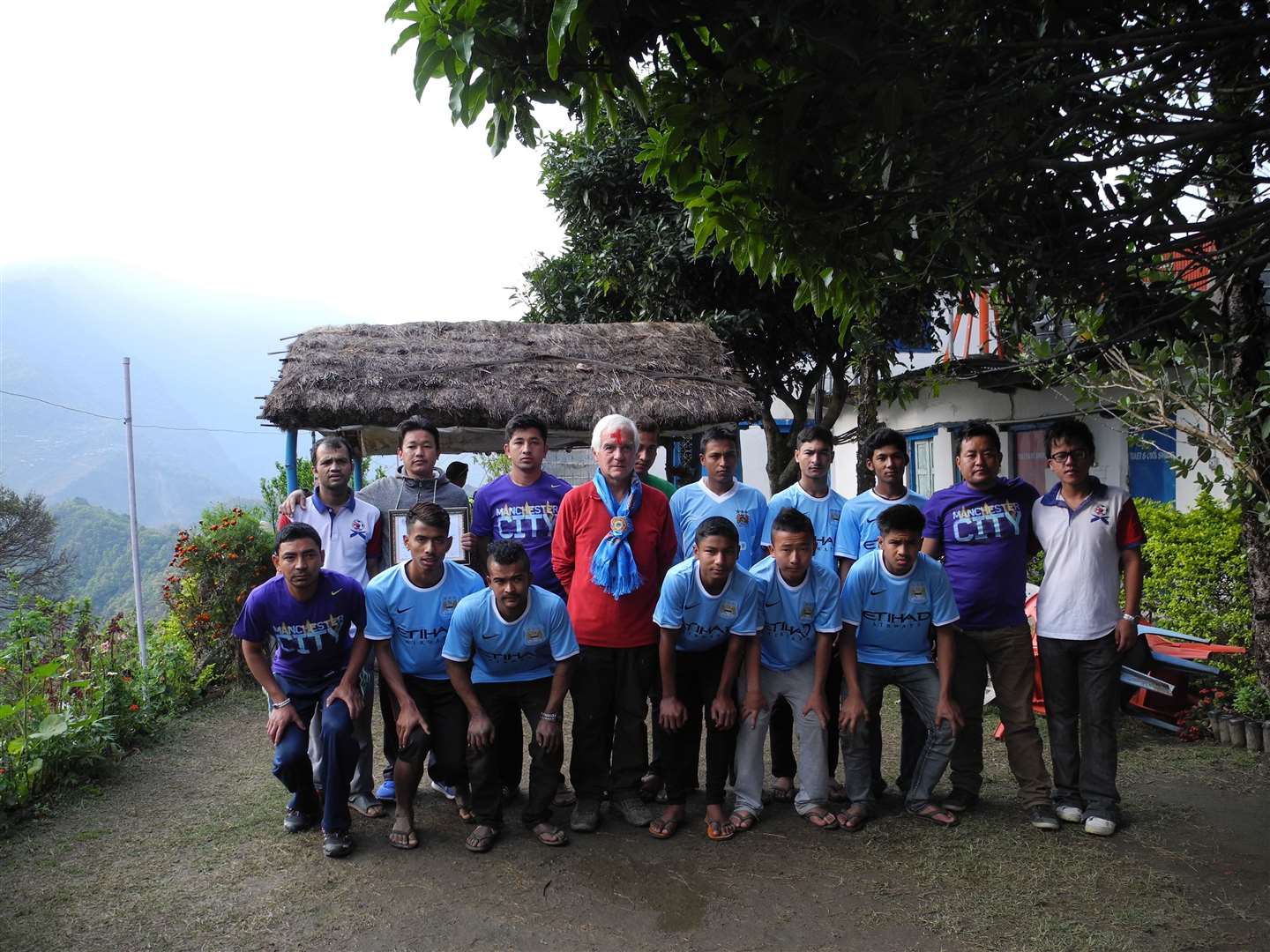 Derek with the young Nepali team in Man City shirts.