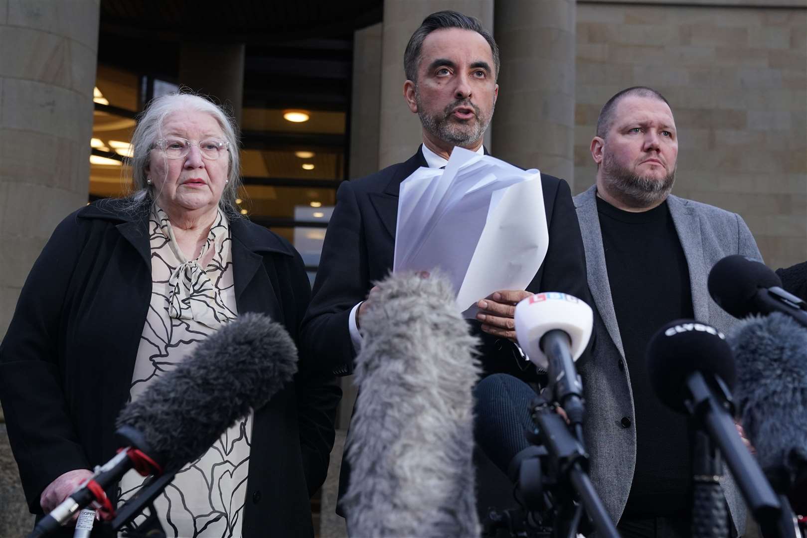 Solicitor Aamer Anwar with Margaret Caldwell and other family members outside the High Court in Glasgow (Andrew Milligan/PA)