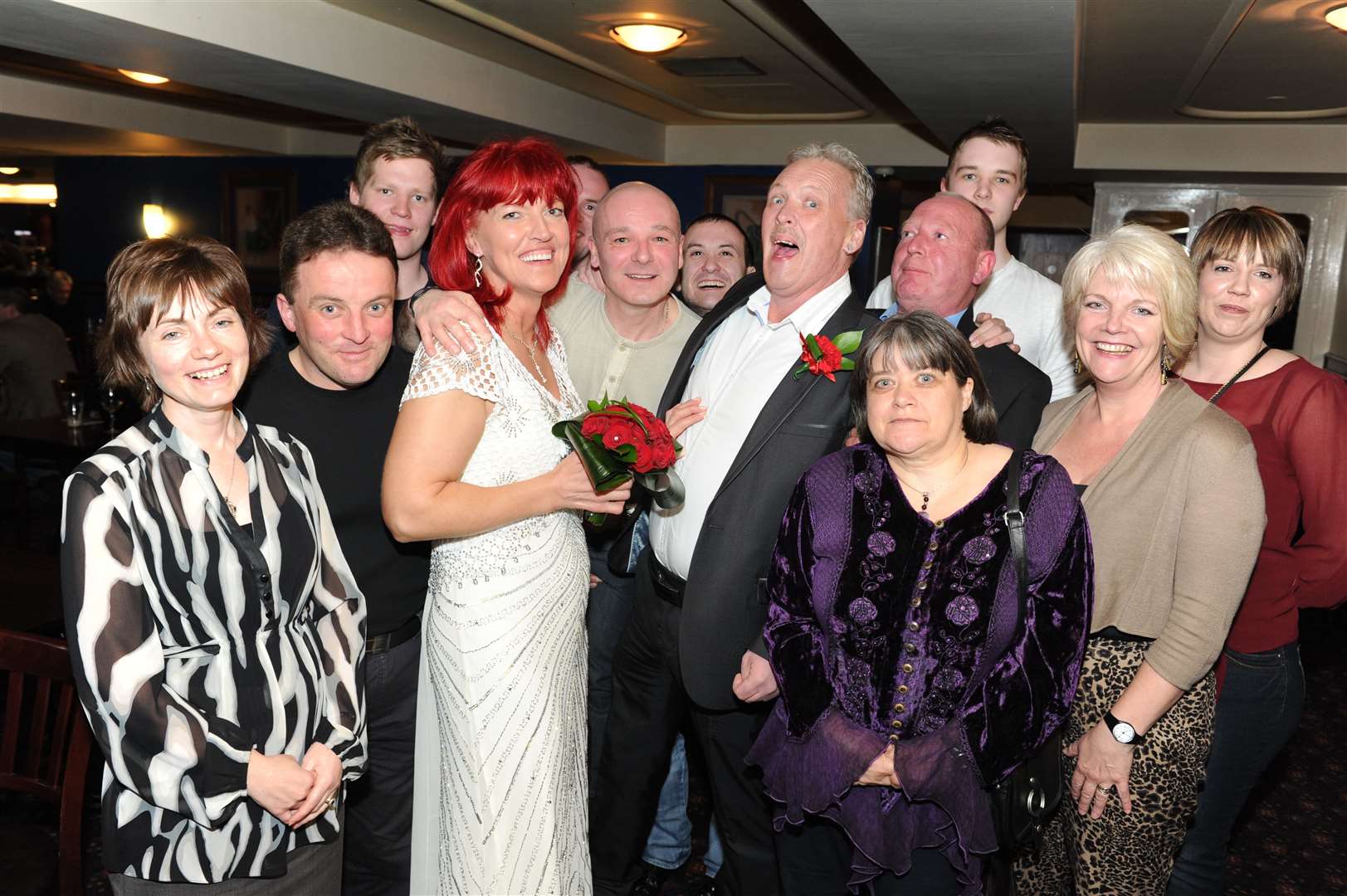 Lilita Vilcina and Paul Williamson (centre) celebrate there wedding with friends and family in Wetherspoons.