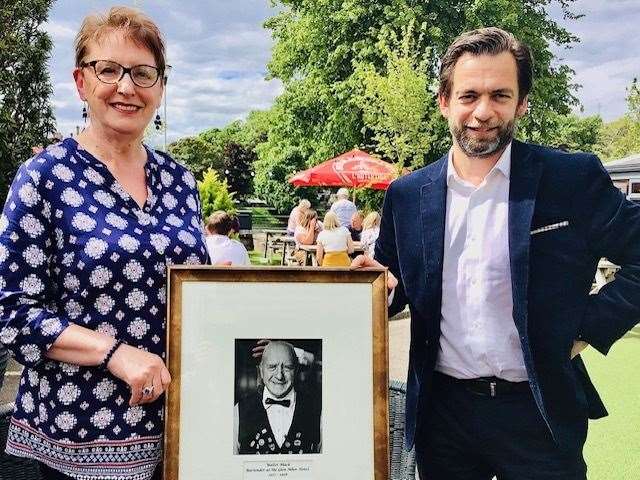 Glen Mhor Hotel manager Emmanuel Moine presents Christine Moffat with the photograph of her dad, Walter Black.
