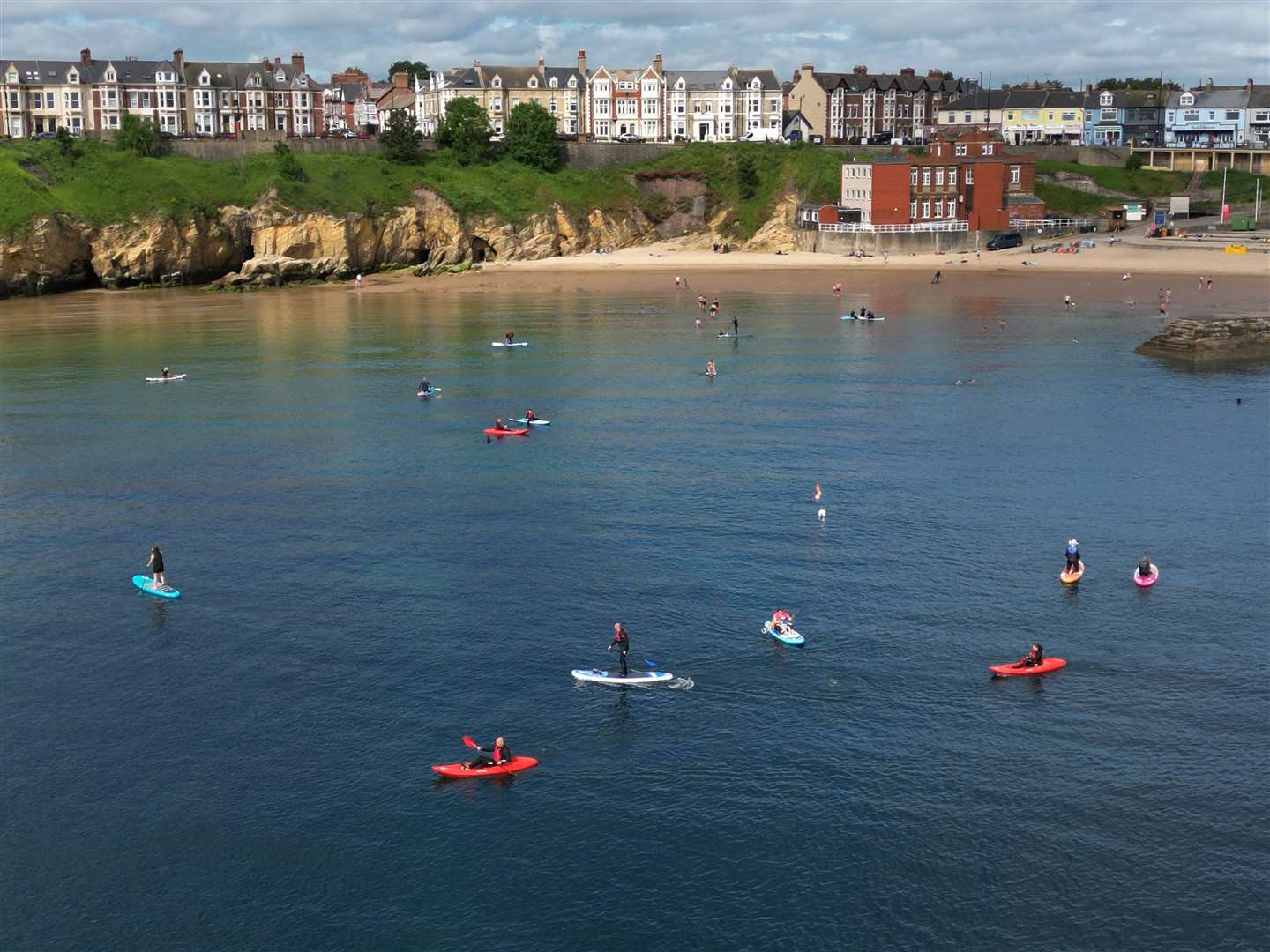 In North Tyneside, the prospect of taking to the water was a welcome relief from the rising temperatures at Cullercoats Bay (Owen Humphries/PA)