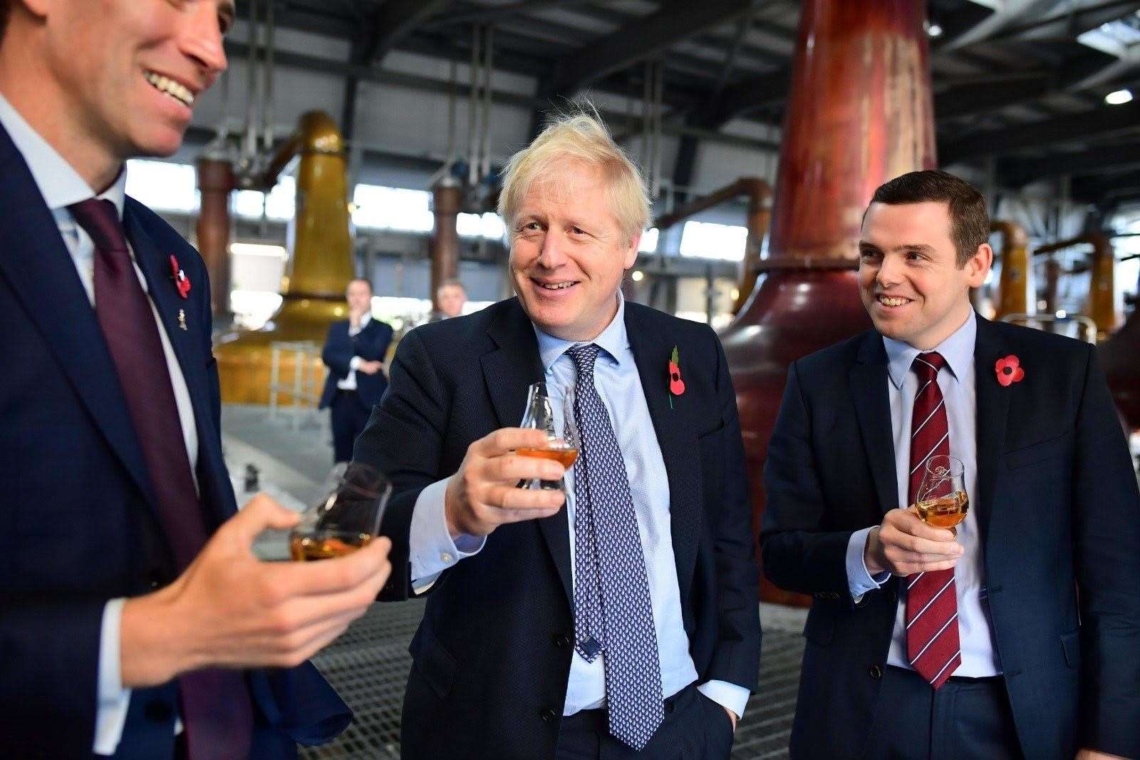 Boris Johnson and Douglas Ross at Roseisle Distillery on last year's campaign trail.