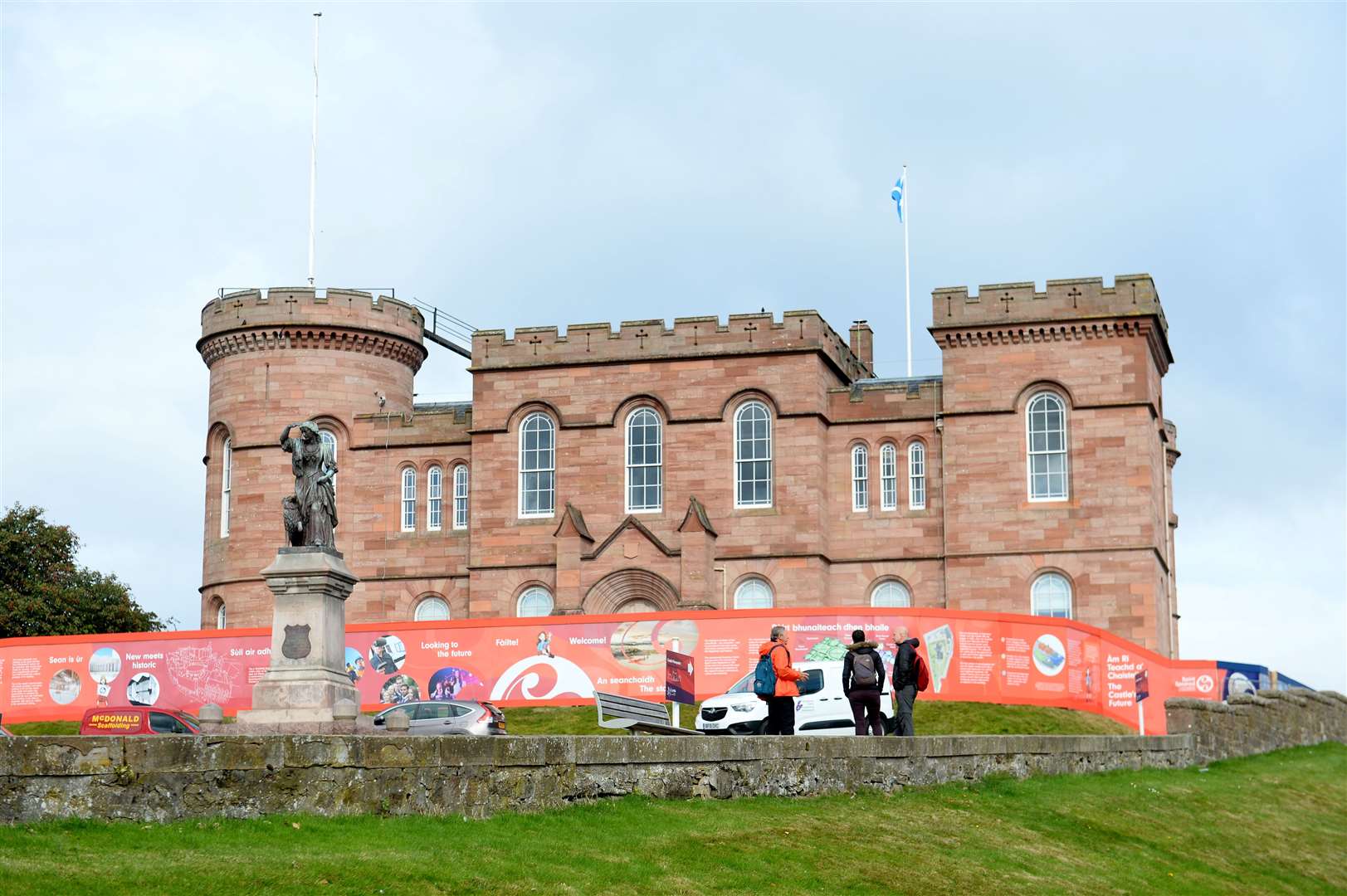 Storyboards are displayed on hoardings at Inverness Castle.
