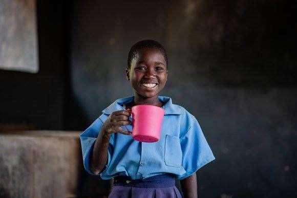 Bertha, 11, enjoys Mary's meals at school in Zambia.