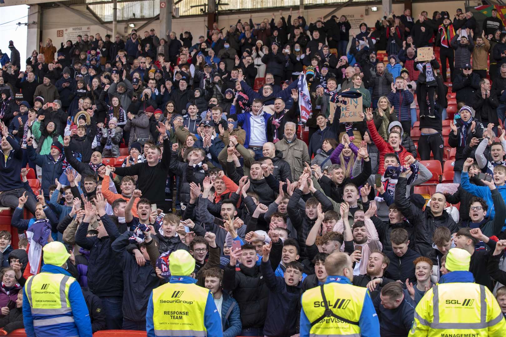 Ross County players fans celebrate at Aberdeen after the Staggies claimed a top six finish.