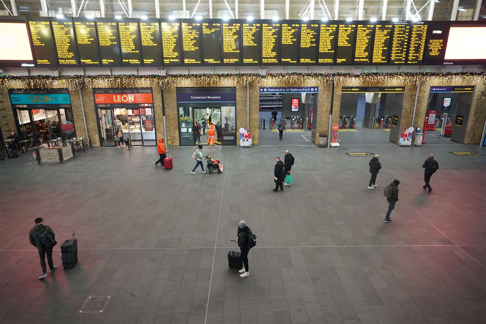 Passengers at King’s Cross in London during strike action by the RMT in December (James Manning/PA)