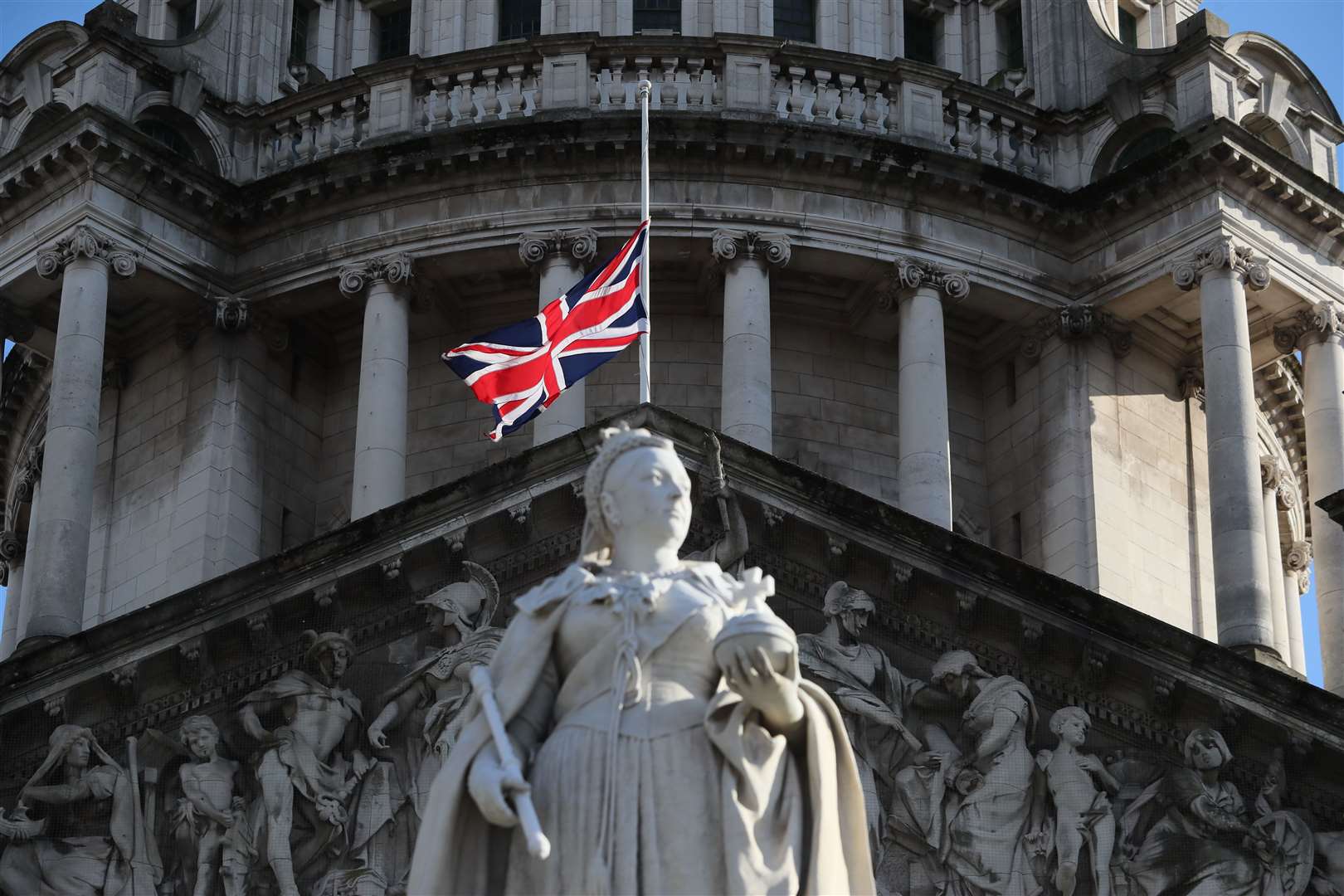 The Union flag flies at half mast over Belfast City Hall following the announcement of the death of the Duke of Edinburgh at the age of 99 (Brian Lawless/PA)
