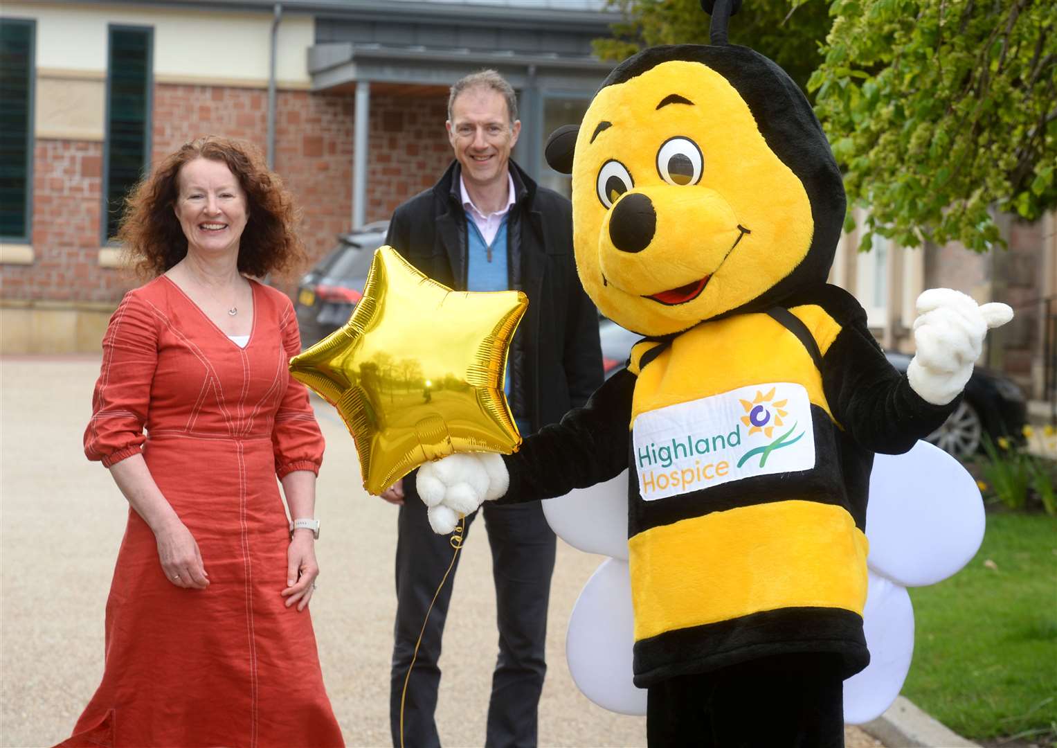 Highland Hospice is awarded an Investors in People Gold Award. Seeing gold are, from left, Linda Lawton, Kenny Steele and hospice mascot Bobby the Bee. Picture: Gary Anthony