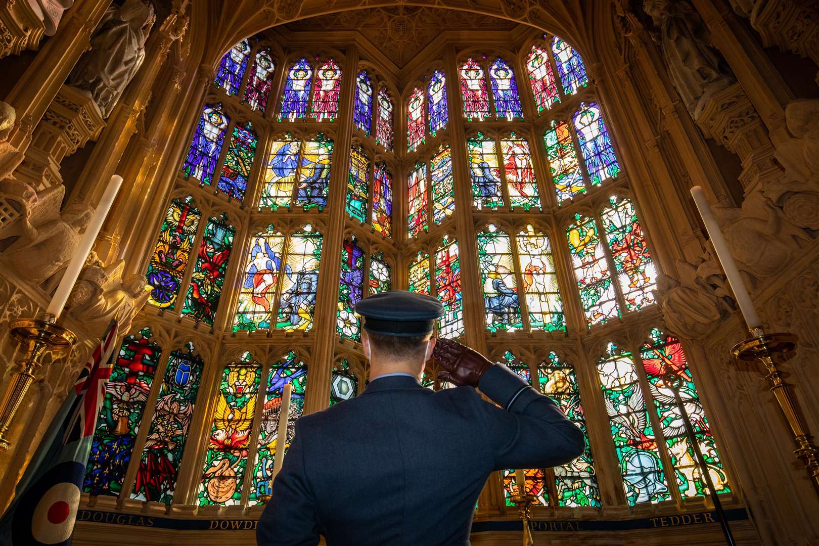 An officer salutes the Battle of Britain memorial window inside Westminster Abbey (Aaron Chown/PA)