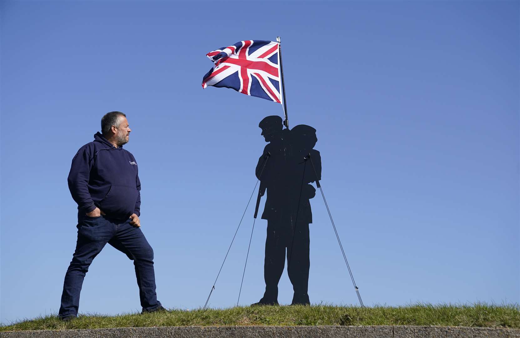 Dan Barton, creator of Standing with Giants, stands next to a silhouette (Andrew Matthews/PA)