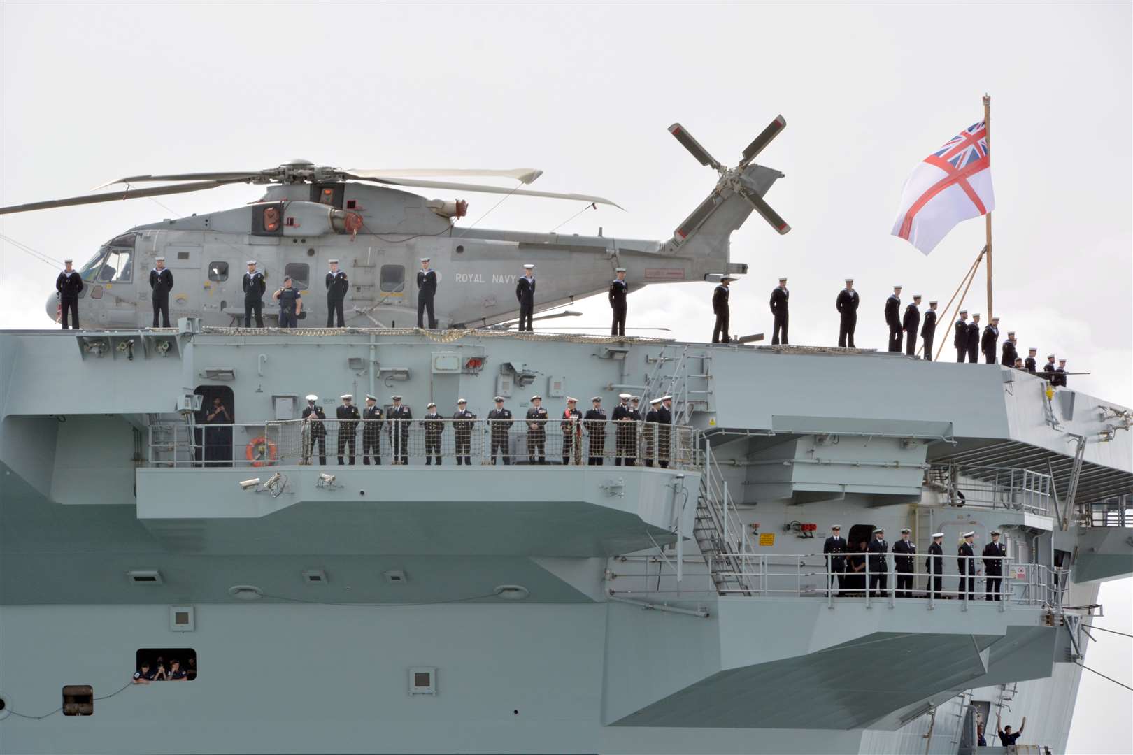 Members of the ship’s company aboard HMS Prince of Wales as it leaves Portsmouth Naval Base (Ben Mitchell/PA)