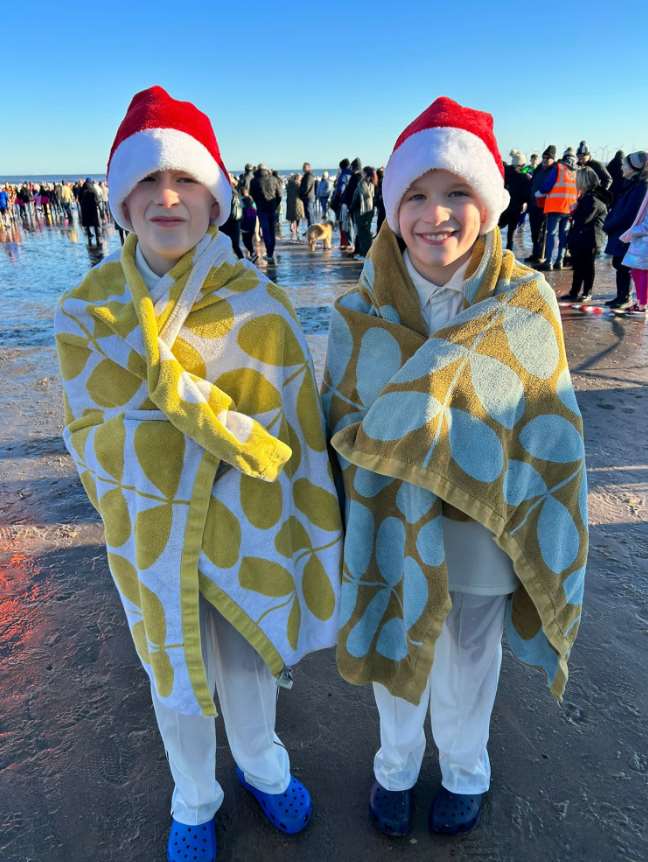 The twins took part in the Boxing Day dip to raise money for cricket nets (Gary Riches/PA)