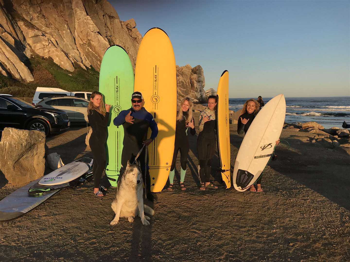Liz Connor with surf instructor Big Kahuna, his dog Big Mountain and three other surfers at Morro Bay. Picture: PA Photo/Liz Connor