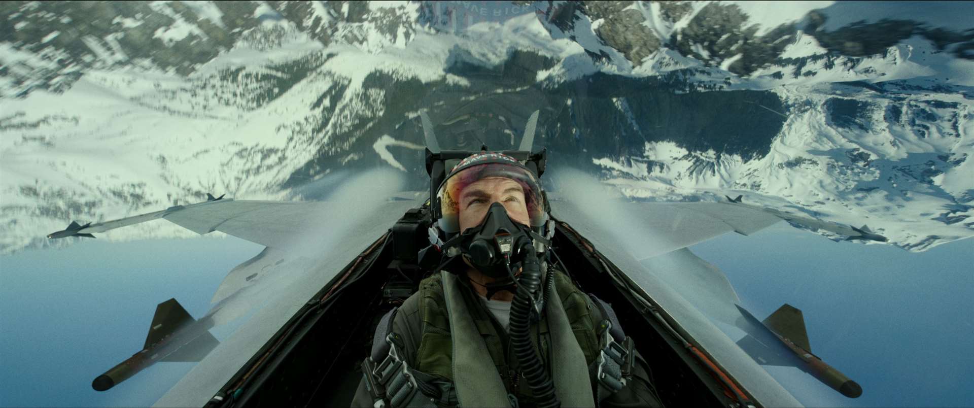 Tom Cruise as Captain Pete "Maverick" Mitchell in the air.