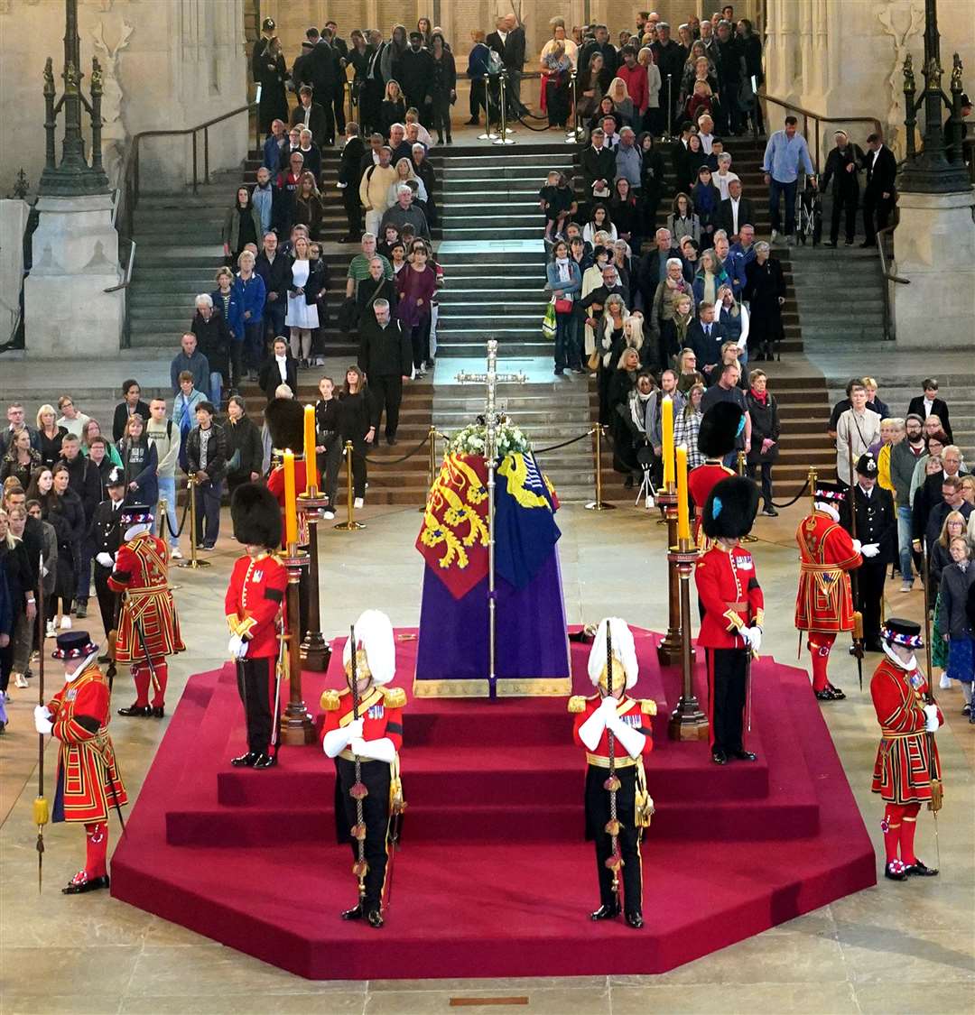 Members of the public file past the coffin of the Queen lying in state on the catafalque in Westminster Hall, at the Palace of Westminster, ahead of her funeral on Monday (Yui Mok/PA)